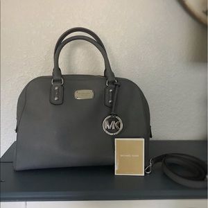 Michael Kors gray bag with shoulder strap.